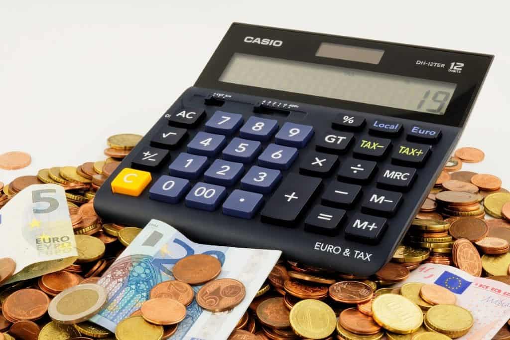 Photo of Calculator Surrounded by Foreign Currency